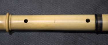 the French flageolet's thumbholes behind the instrument